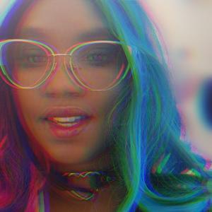 An image of Albi wearing a rainbow wig, the image slightly blurred 3D style